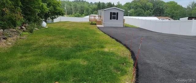 a view of a house with a backyard