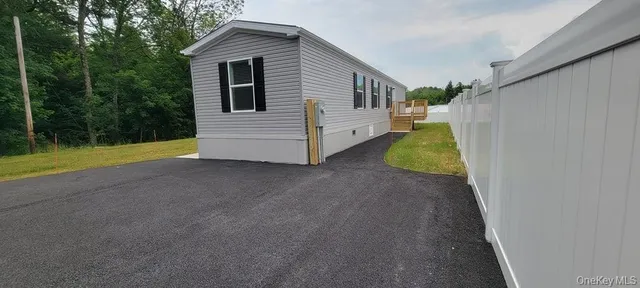 a view of a house with backyard and trees