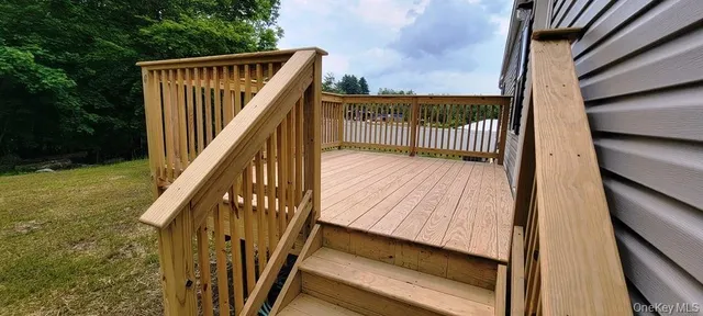 a view of deck with wooden floor and fence
