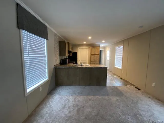 a view of kitchen and kitchen with microwave