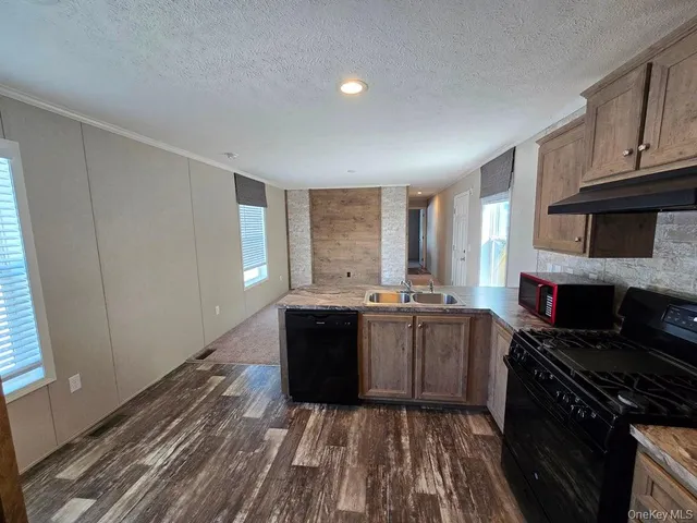 a kitchen with sink stove and cabinets