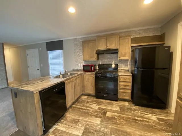 a kitchen with granite countertop a refrigerator and a stove top oven