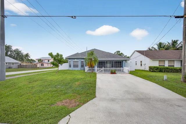 a front view of house with yard and outdoor seating