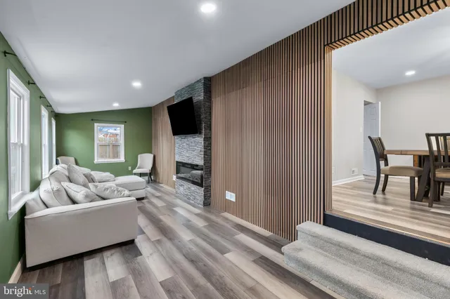 a view of a dining room with furniture a chandelier and wooden floor