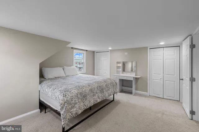 a bedroom with a large bed and a window