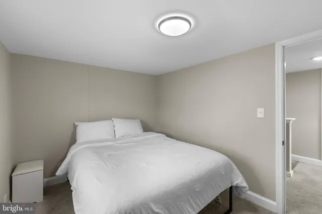 a spacious bedroom with a bed and a window