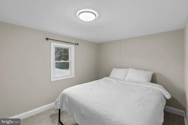 a bedroom with a bed and a night stand