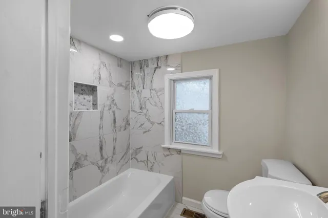 a bedroom with a bed and a sink