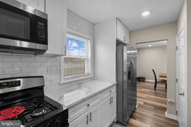 a kitchen with stainless steel appliances a stove sink microwave and cabinets