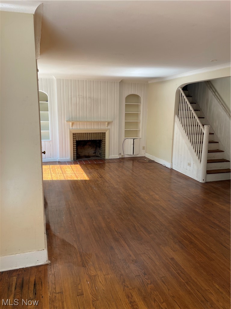 1730 Wood Road Cleveland Heights, OH 44121 - Photo 2 of 34 Living room featuring built in features, wood-type flooring, and a fireplace