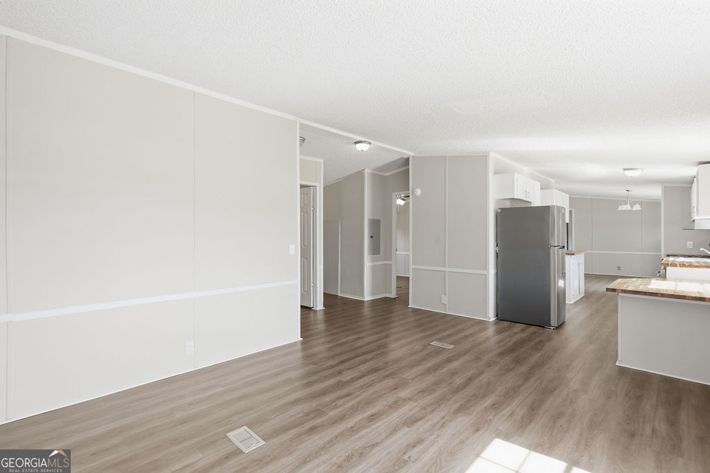 196 Barn Rd Circle Jesup, GA 31545 - Photo 11 of 31 a view of kitchen with a refrigerator wooden floor and a window