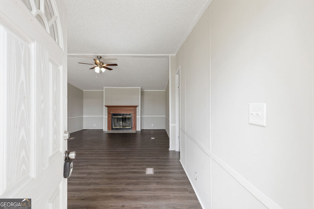196 Barn Rd Circle Jesup, GA 31545 - Photo 2 of 31 a view of an empty room with wooden floor and a window