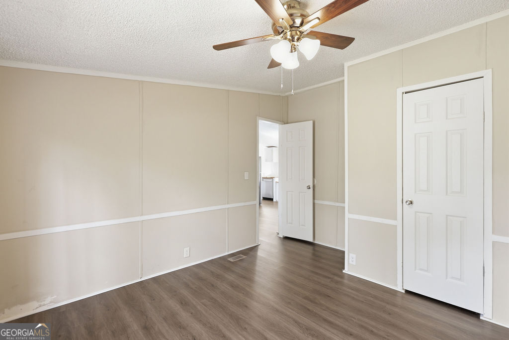 196 Barn Rd Circle Jesup, GA 31545 - Photo 23 of 31 an empty room with wooden floor closet and windows