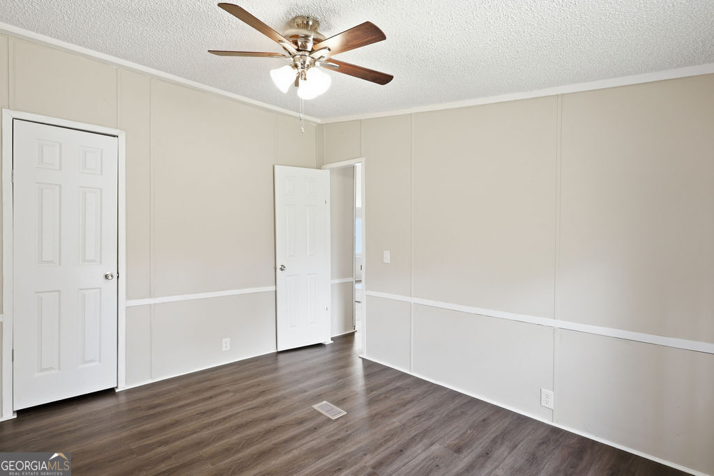196 Barn Rd Circle Jesup, GA 31545 - Photo 26 of 31 a view of an empty room with wooden floor