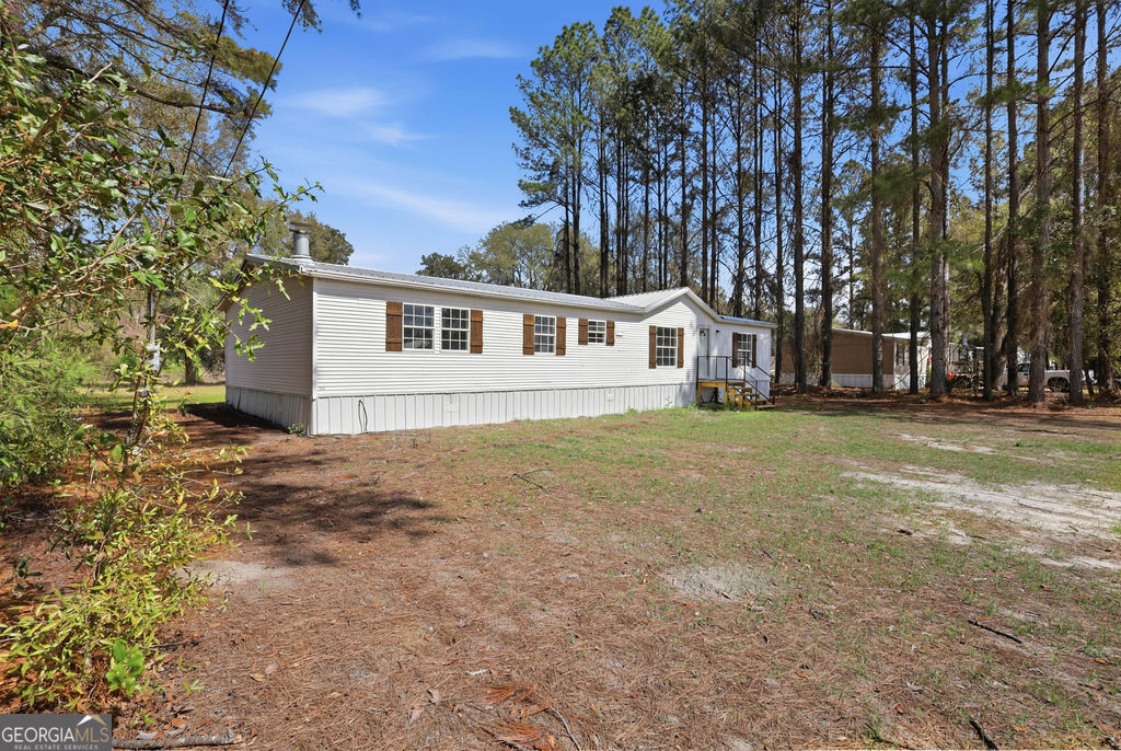 196 Barn Rd Circle Jesup, GA 31545 - Photo 28 of 31 front view of house with a yard