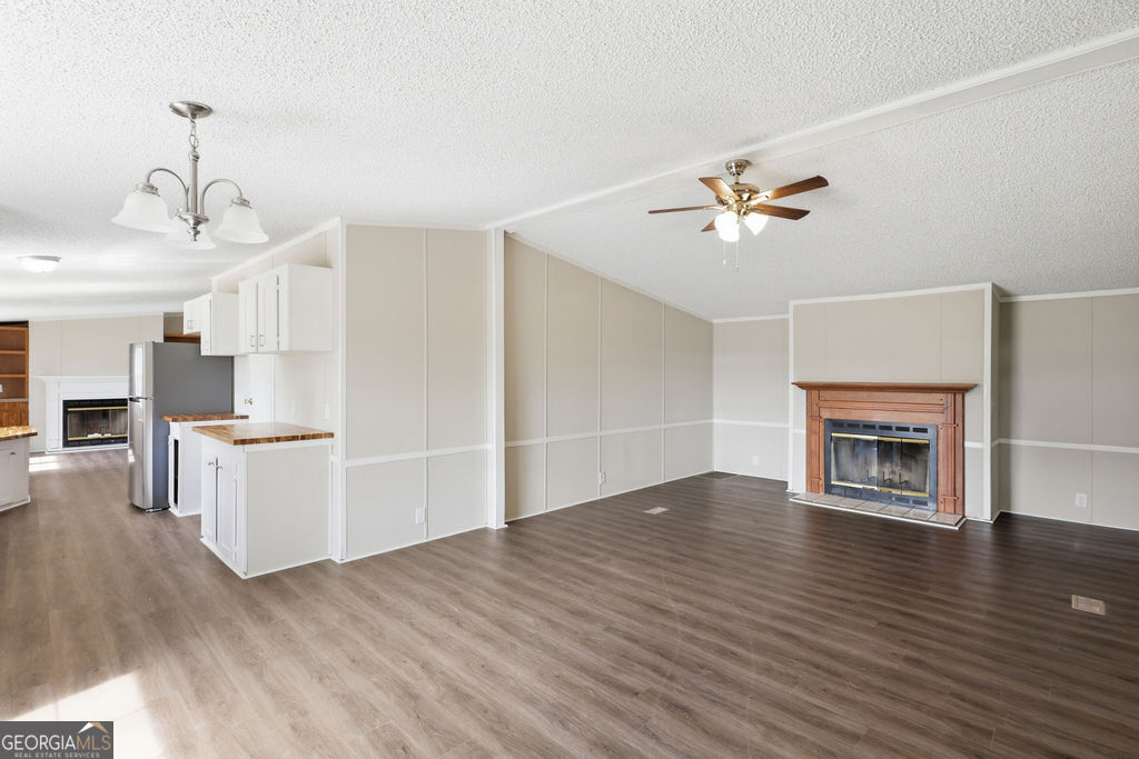 196 Barn Rd Circle Jesup, GA 31545 - Photo 3 of 31 a view of a kitchen with a sink a kitchen island wooden floor and a fireplace
