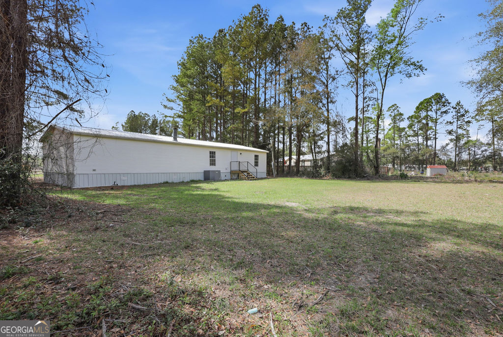 196 Barn Rd Circle Jesup, GA 31545 - Photo 31 of 31 a view of backyard with green space