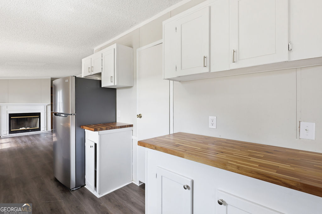 196 Barn Rd Circle Jesup, GA 31545 - Photo 8 of 31 a kitchen with granite countertop white cabinets and refrigerator