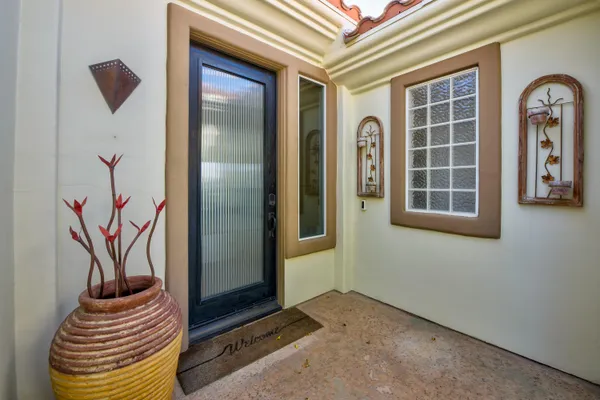 a kitchen with granite countertop a sink and white cabinets