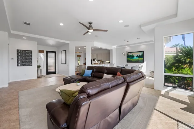 a bedroom with a large bed and a large window