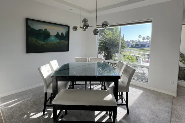 a bedroom with a bed a couch and a large window