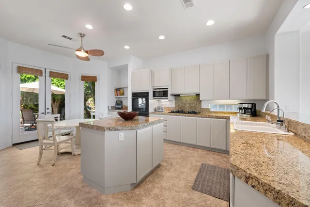 a bedroom with a bed a dresser and a bookshelf with wooden floor