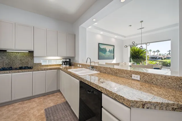 a bedroom with a bed and a dresser next to a window