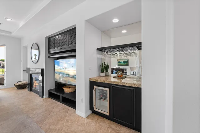 a view of a swimming pool and lounge chairs in the patio