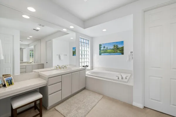 a view of a swimming pool with a patio and a yard