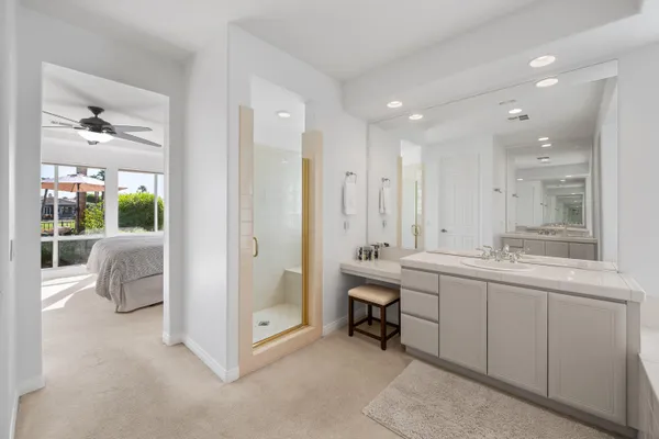 a view of the patio with chairs under an umbrella