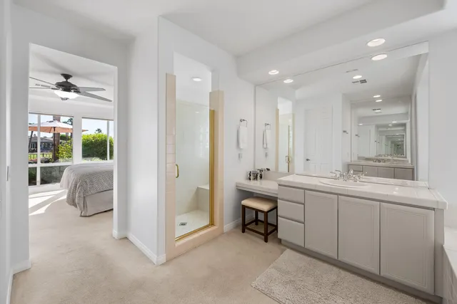 a view of the patio with chairs under an umbrella