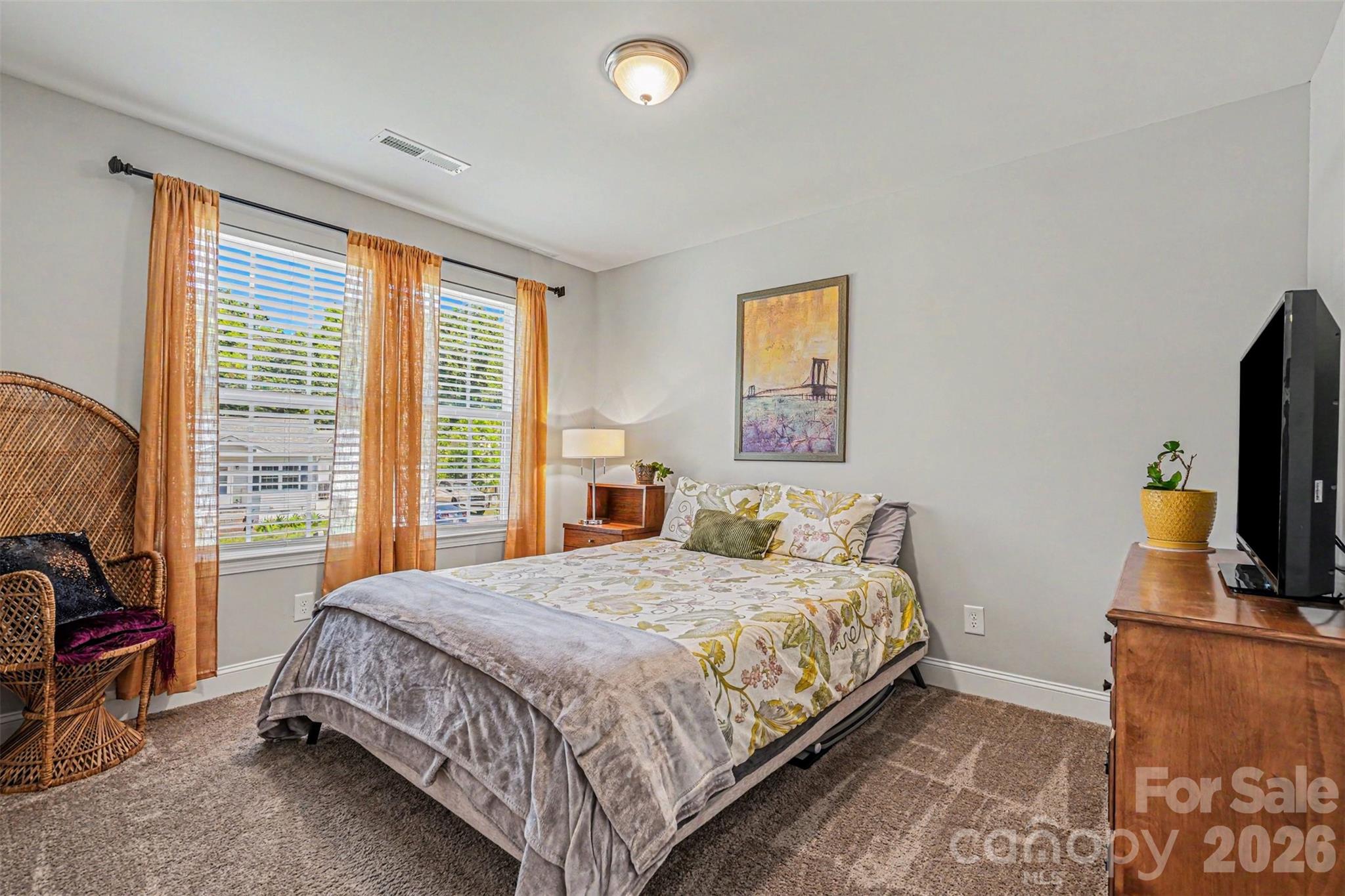 1610 Walter Hasty Road Monroe, NC 28110 - Photo 27 of 32 a bedroom with a bed a flat screen tv and next to a window