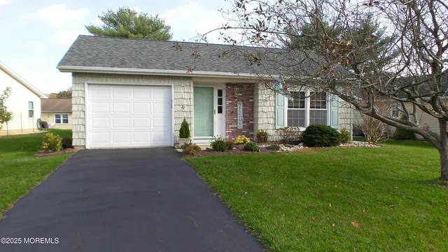 a front view of a house with a garden and plants