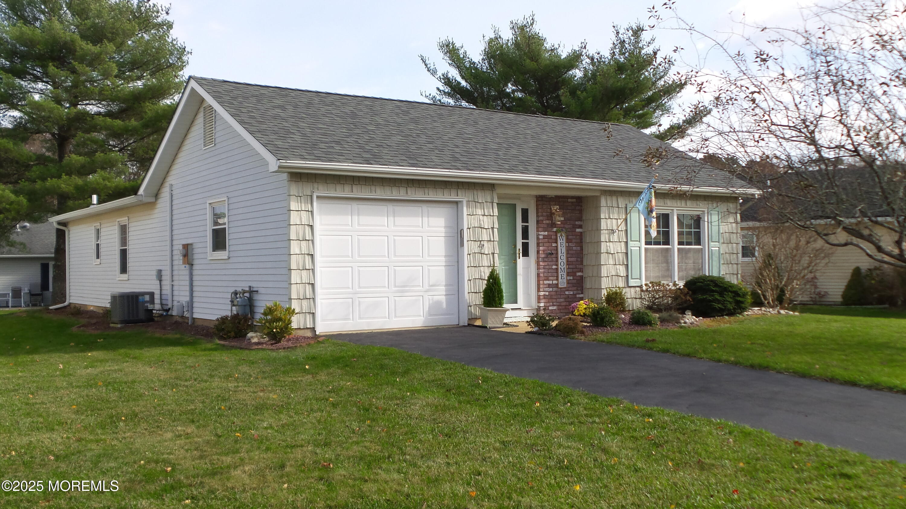4 Olympus Way Brick, NJ 08724 - Photo 3 of 39 a front view of a house with a yard and garage