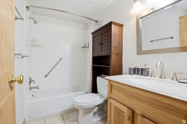 4245 3320 East Holladay, UT 84124 - Photo 31 of 51 Bathroom featuring a single-basin vanity with a light-toned countertop, a shower-tub combination with subway tile surround, and a dark wood-finish storage cabinet
