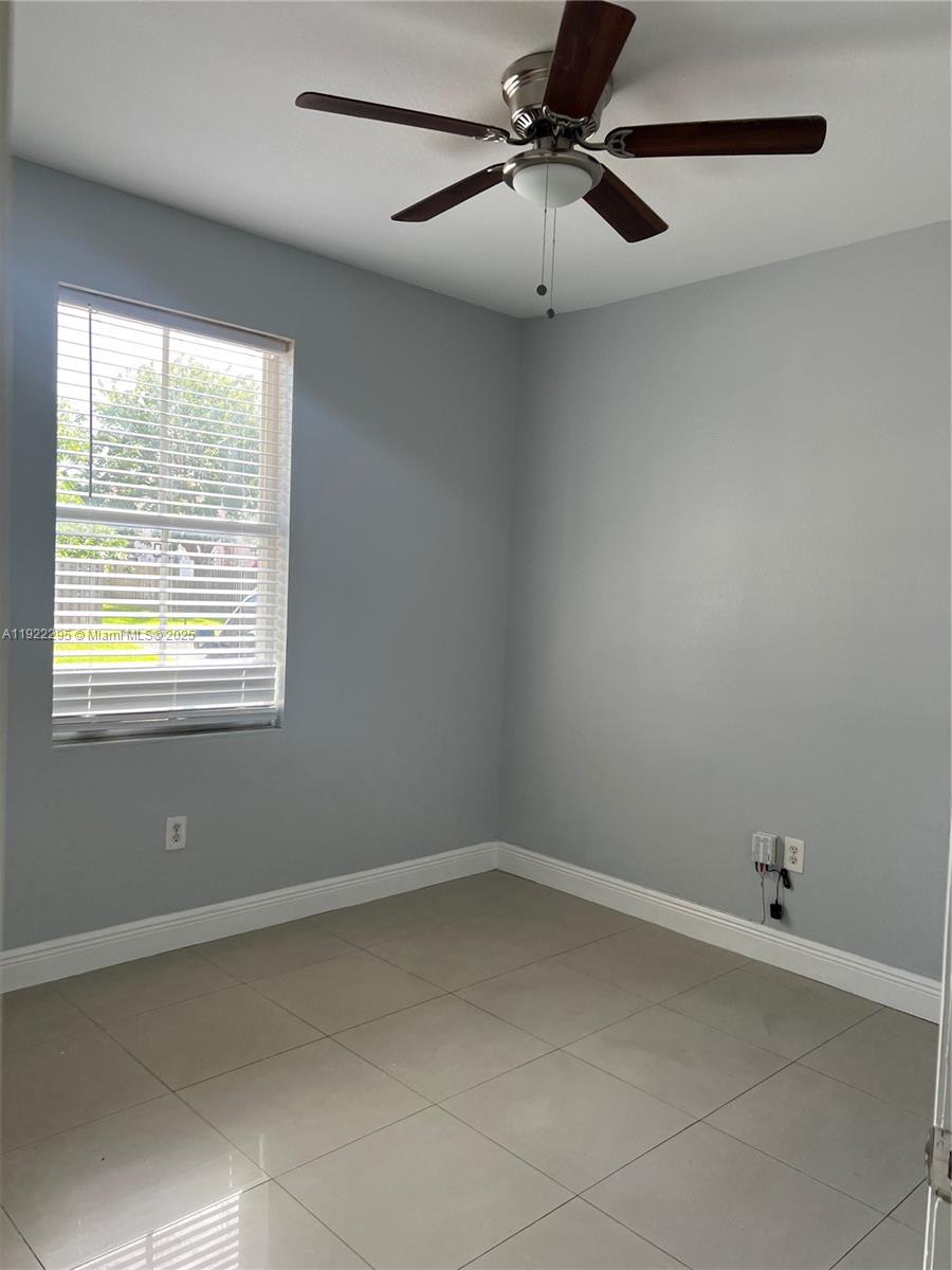 27510 Southwest 138th Path Homestead, FL 33032 - Photo 11 of 35 an empty room with a window and a fan