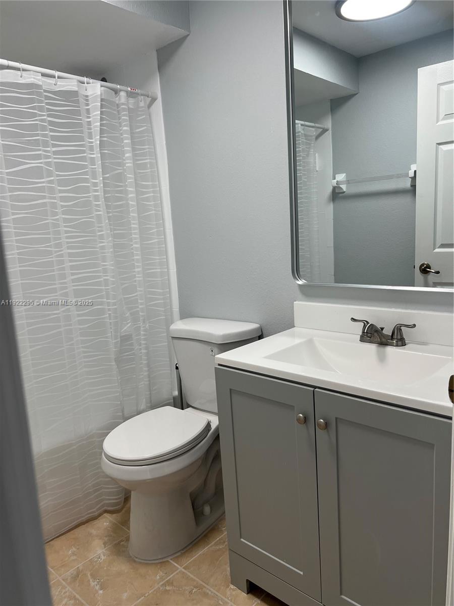 27510 Southwest 138th Path Homestead, FL 33032 - Photo 13 of 35 a bathroom with a sink a toilet and mirror