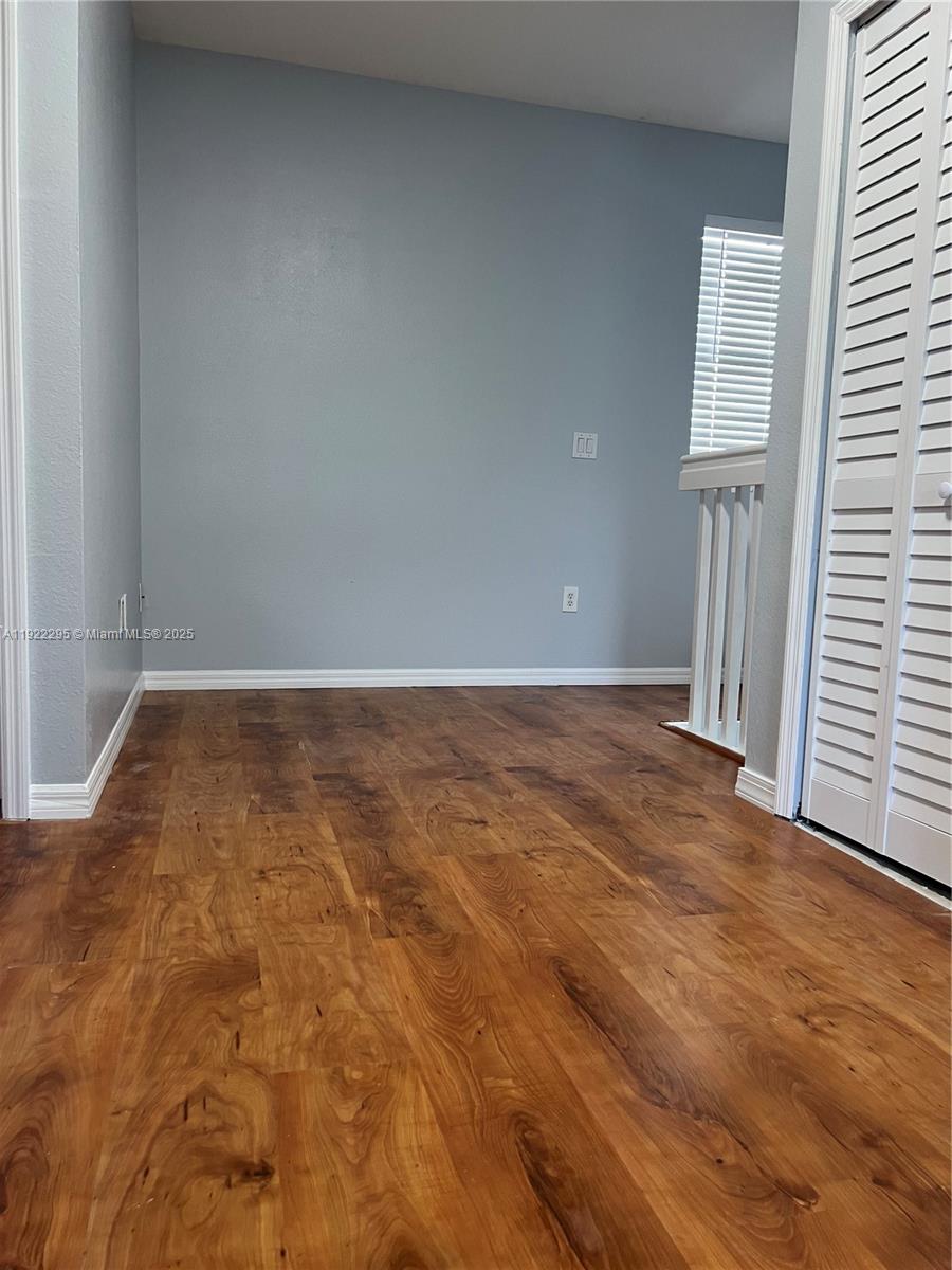 27510 Southwest 138th Path Homestead, FL 33032 - Photo 16 of 35 an empty room with wooden floor and closet