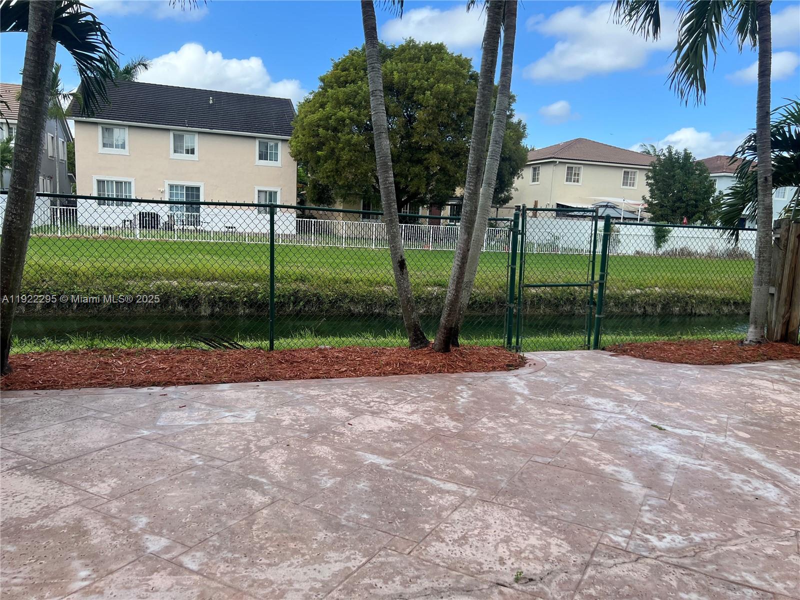 27510 Southwest 138th Path Homestead, FL 33032 - Photo 26 of 35 a view of a house with a yard and palm trees