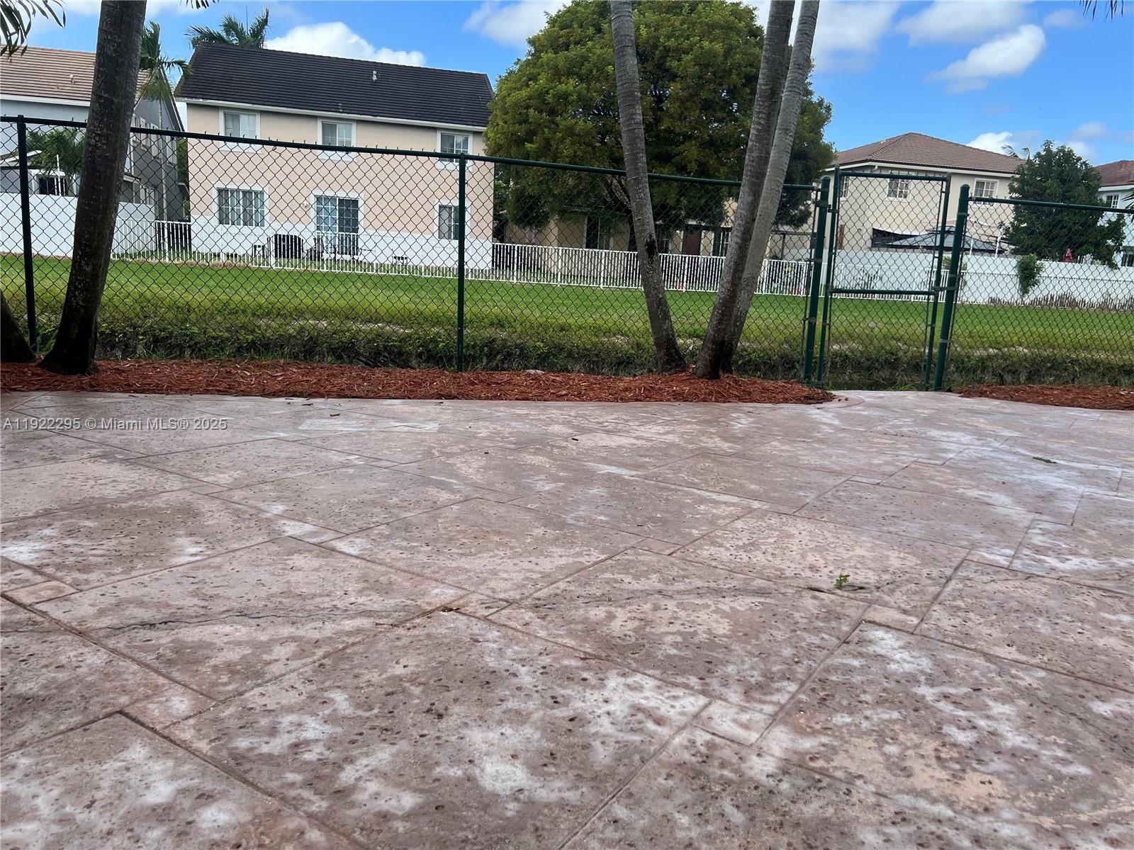 27510 Southwest 138th Path Homestead, FL 33032 - Photo 29 of 35 a view of a house with a small yard and large trees