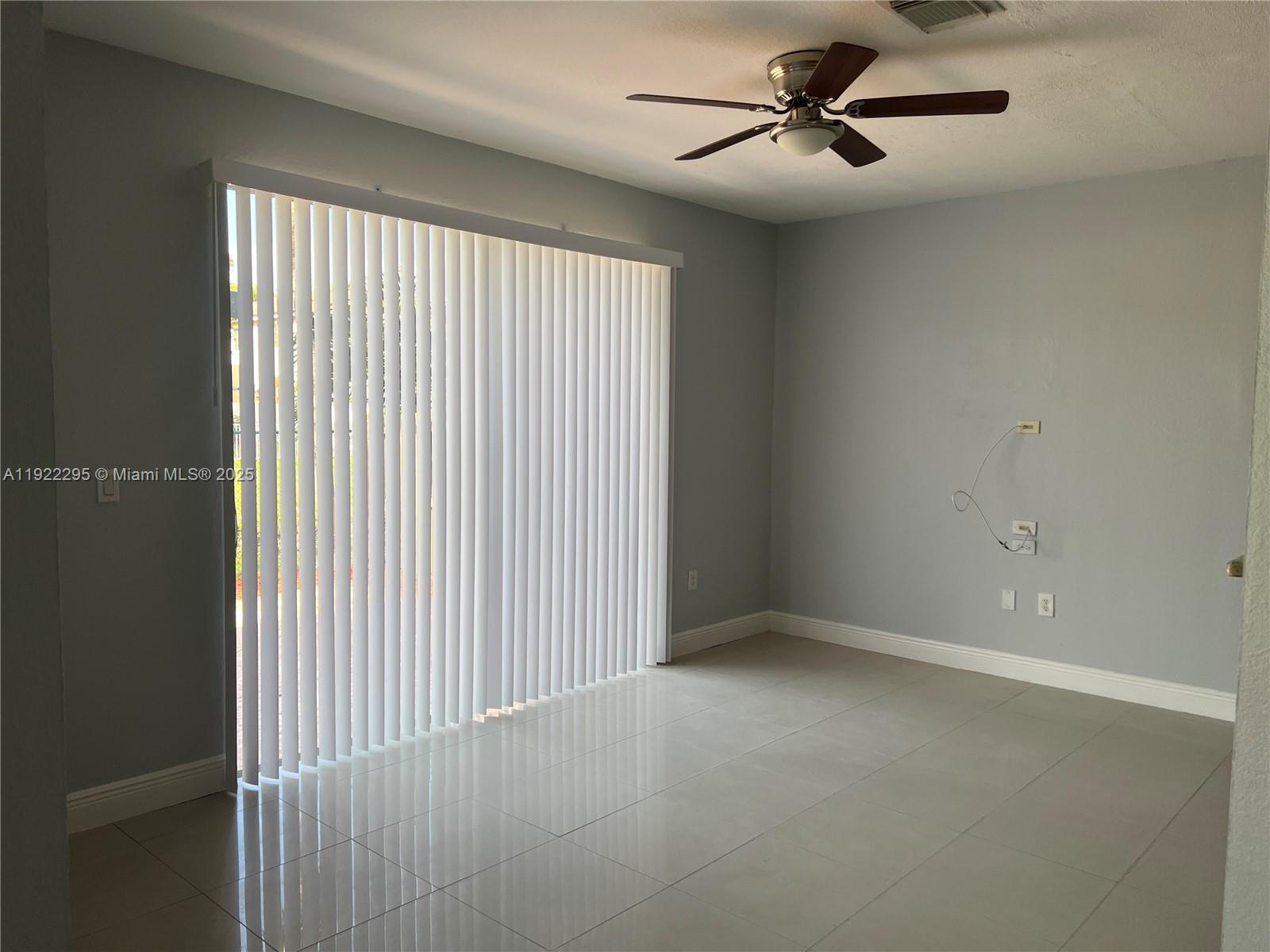 27510 Southwest 138th Path Homestead, FL 33032 - Photo 6 of 35 a view of an empty room with a window