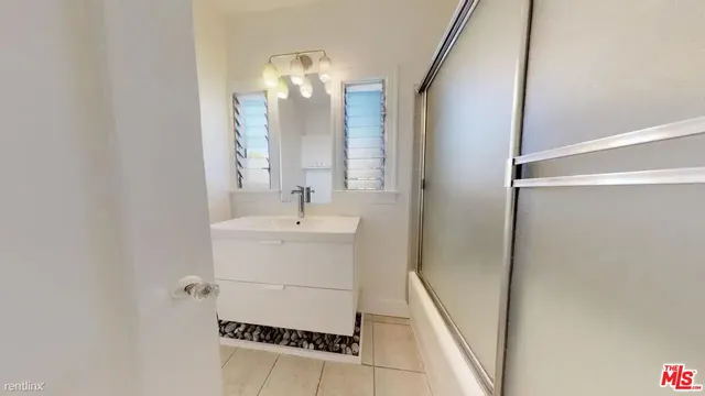 a bathroom with a sink and mirror