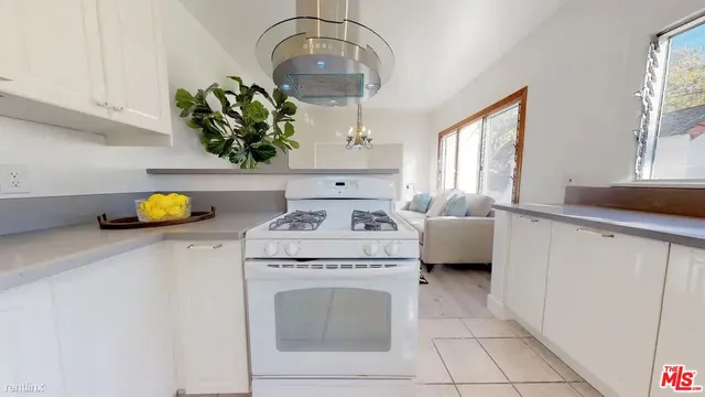 a kitchen with a white cabinets and stove