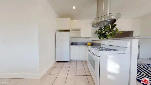 a kitchen with stainless steel appliances granite countertop a stove a refrigerator and a microwave