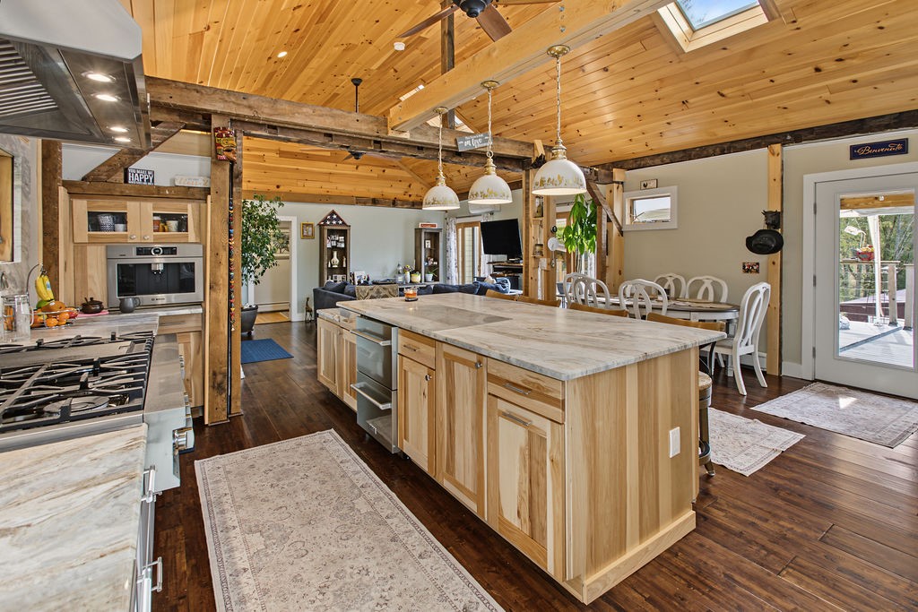 1668 Vandervort Hill Road Unadilla, NY 13849 - Photo 12 of 50 Gleaming hardwood floors and natural wood ceilings enhance this inviting open-concept kitchen space.