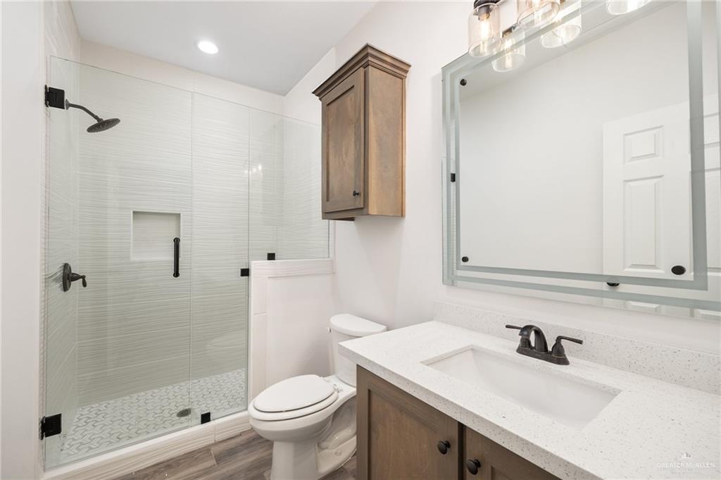 1010 Azalea Street Mission, TX 78573 - Photo 11 of 12 a bathroom with a sink a toilet and shower