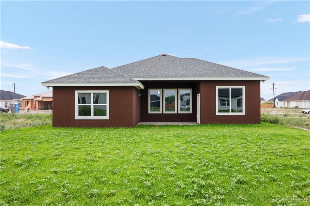1010 Azalea Street Mission, TX 78573 - Photo 12 of 12 a front view of a house with garden