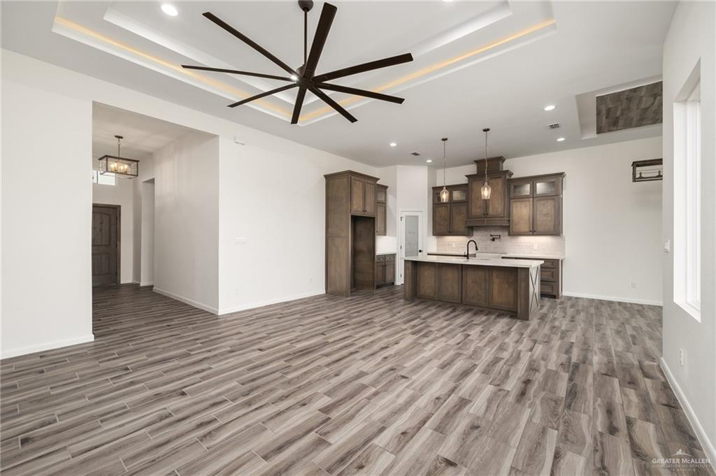 1010 Azalea Street Mission, TX 78573 - Photo 2 of 12 a view of kitchen with refrigerator stove and wooden floor