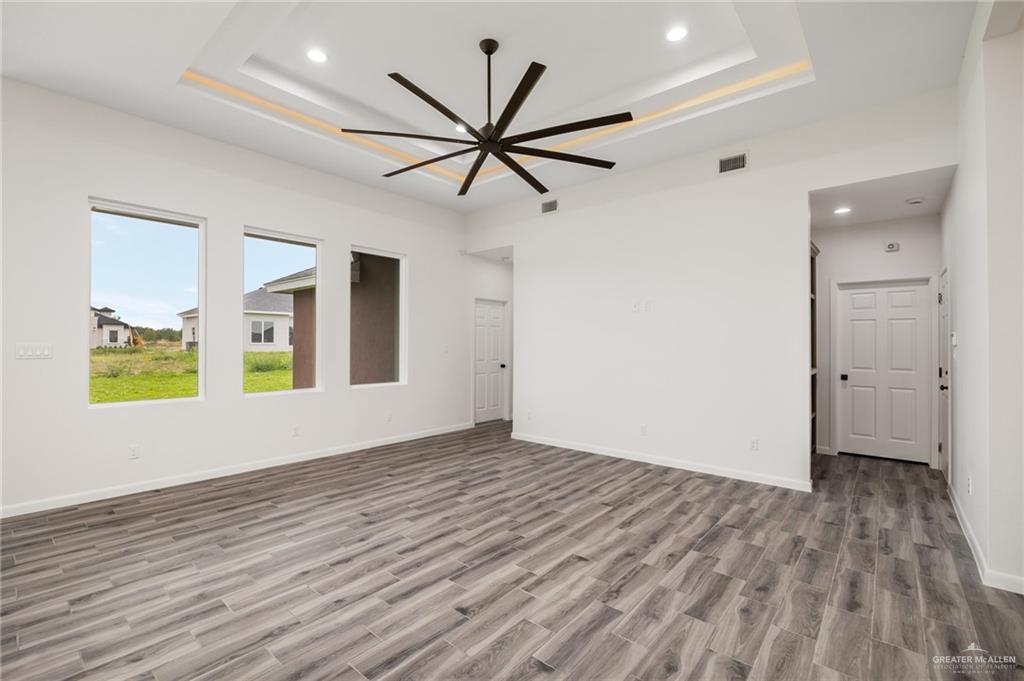 1010 Azalea Street Mission, TX 78573 - Photo 3 of 12 wooden floor in an empty room with a window