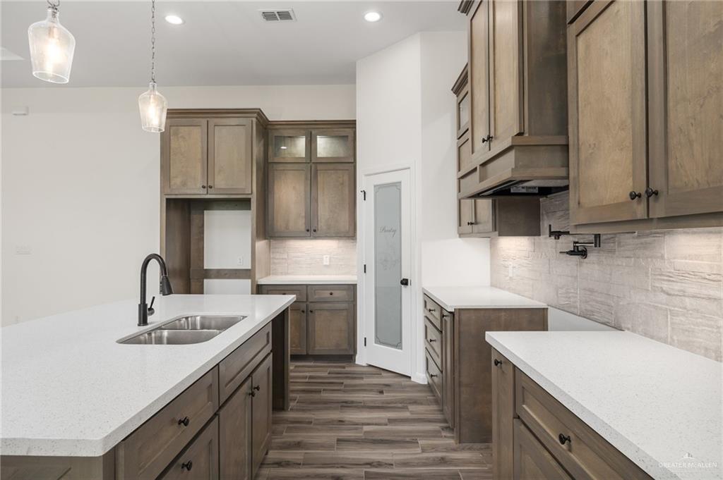 1010 Azalea Street Mission, TX 78573 - Photo 6 of 12 a kitchen with a sink stove and cabinets